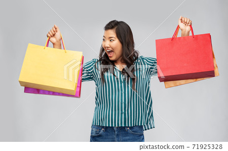 happy asian woman with shopping bags happy asian woman with shopping bags 71925328