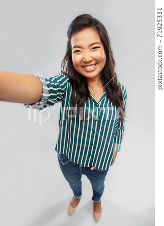 happy smiling asian woman taking selfie happy smiling asian woman taking selfie 71925331