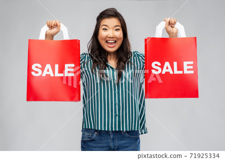happy asian woman with shopping bags happy asian woman with shopping bags 71925334