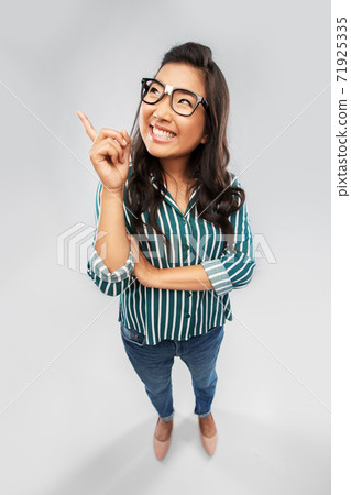 smiling asian student woman pointing finger up smiling asian student woman pointing finger up 71925335