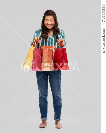 happy asian woman with shopping bags happy asian woman with shopping bags 71925336