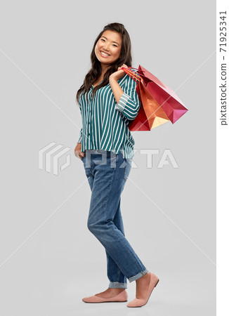 happy asian woman with shopping bags 71925341