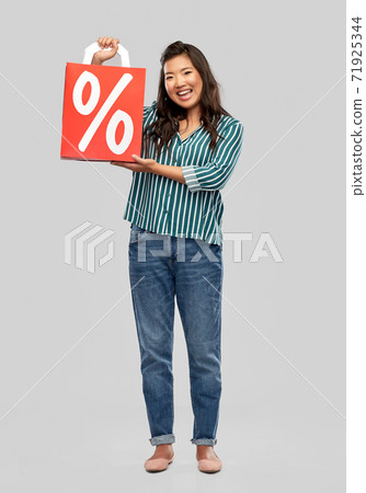 asian woman with percentage sign on shopping bags 71925344