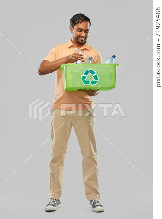 smiling young indian man sorting plastic waste smiling young indian man sorting plastic waste 71925488