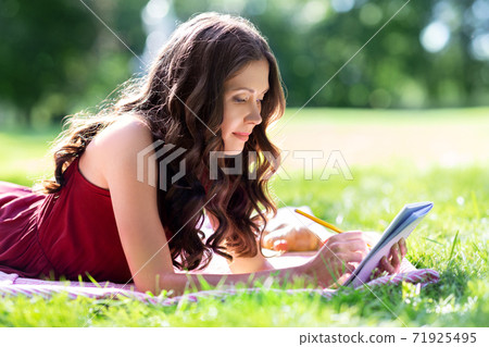 happy woman with diary or notebook at park happy woman with diary or notebook at park 71925495