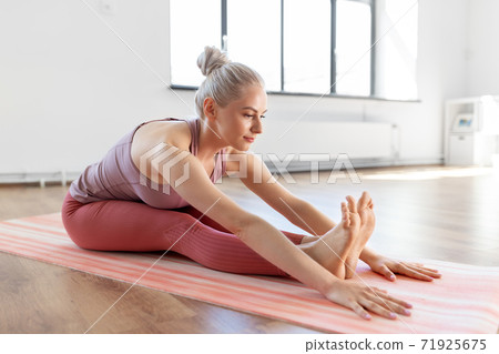 young woman doing yoga exercise at home young woman doing yoga exercise at home 71925675