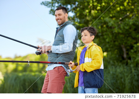 happy smiling father and son fishing on river happy smiling father and son fishing on river 71925678