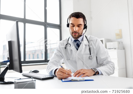 male doctor with headset and clipboard at hospital 71925680