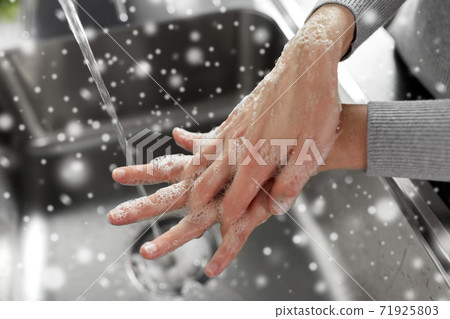 woman washing hands with soap in kitchen woman washing hands with soap in kitchen 71925803