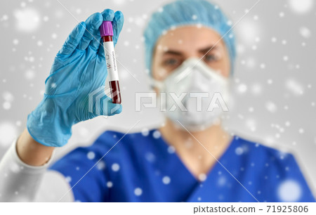 doctor holding beaker with coronavirus blood test 71925806