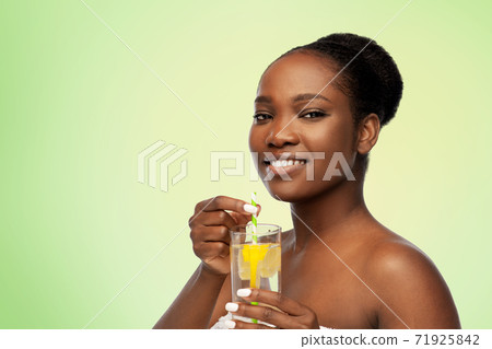 african american woman with glass of fruit water african american woman with glass of fruit water 71925842