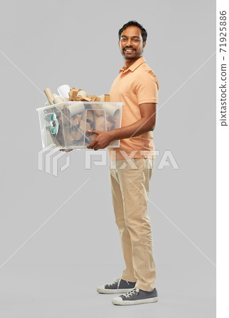 smiling young indian man sorting paper waste 71925886