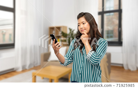 asian woman using smartphone at home asian woman using smartphone at home 71925985