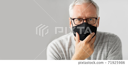 close up of senior man in glasses and black mask close up of senior man in glasses and black mask 71925986
