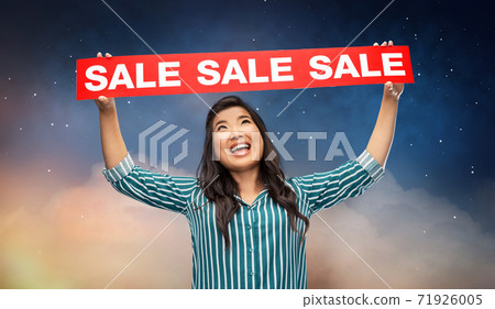 happy smiling young asian woman with sale banner happy smiling young asian woman with sale banner 71926005
