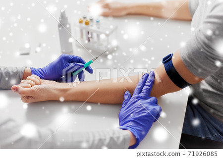 doctor taking blood for test from patient's hand doctor taking blood for test from patient's hand 71926085