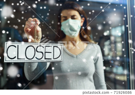 woman in mask hanging banner closed on door woman in mask hanging banner closed on door 71926086