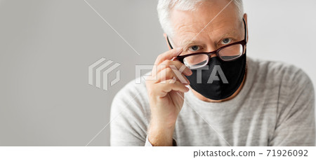 close up of senior man in glasses and black mask close up of senior man in glasses and black mask 71926092