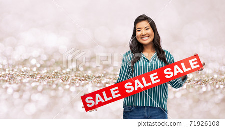 happy smiling young asian woman with sale banner 71926108