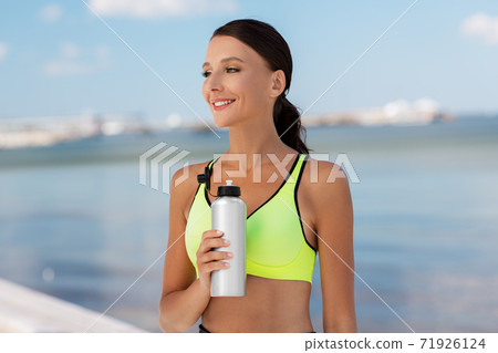 woman drinking water from bottle after sports woman drinking water from bottle after sports 71926124