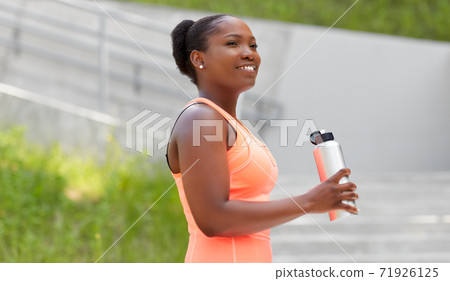 african american woman drinking water from bottle african american woman drinking water from bottle 71926125