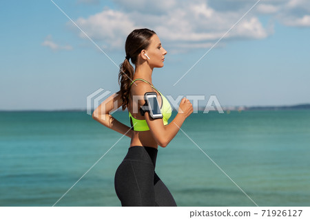 woman with earphones and smartphone running woman with earphones and smartphone running 71926127