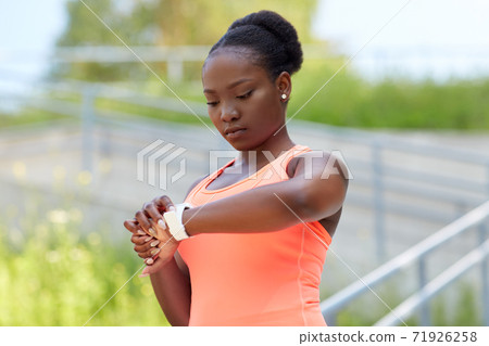 african woman with smart watch doing sports african woman with smart watch doing sports 71926258
