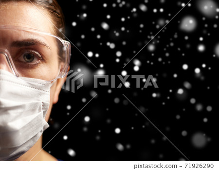 female doctor or nurse in goggles and face mask female doctor or nurse in goggles and face mask 71926290