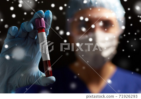 doctor holding beaker with coronavirus blood test doctor holding beaker with coronavirus blood test 71926293