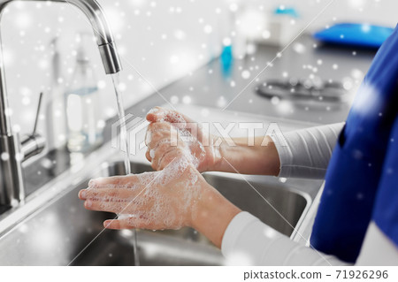 doctor or nurse washing hands with liquid soap doctor or nurse washing hands with liquid soap 71926296