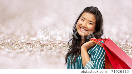 happy asian woman with shopping bags happy asian woman with shopping bags 71926313