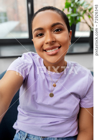 happy african american woman taking selfie at home 71926348