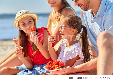happy family having picnic on summer beach 71926549