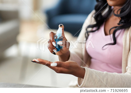 close up of woman spraying hand sanitizer close up of woman spraying hand sanitizer 71926695