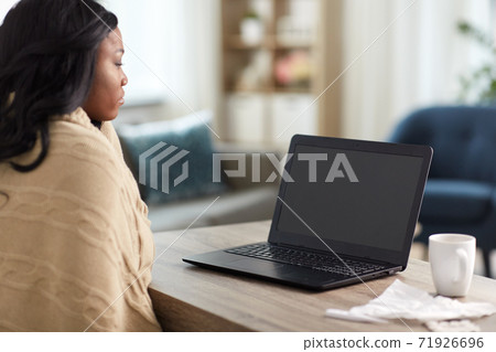 sick woman having video call on laptop sick woman having video call on laptop 71926696