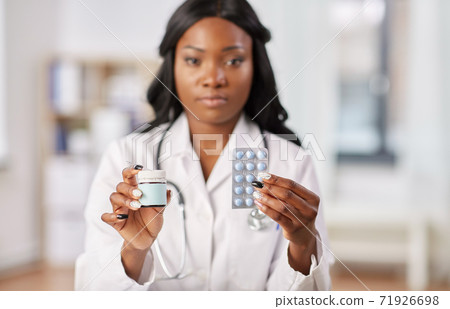 african american doctor with medicine at hospital 71926698