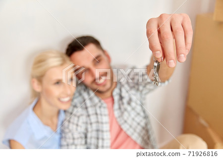 happy couple with key and boxes moving to new home 71926816