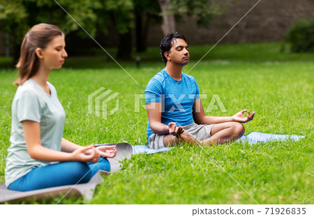 group of people doing yoga at summer park group of people doing yoga at summer park 71926835
