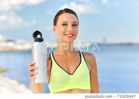 woman drinking water from bottle after sports woman drinking water from bottle after sports 71926847