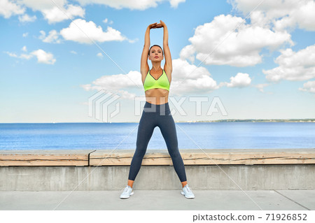 young woman doing sports on sea promenade young woman doing sports on sea promenade 71926852