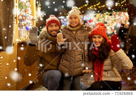 happy family waving hands at christmas market happy family waving hands at christmas market 71926868