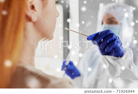 doctor in protective wear making coronavirus test 71926944