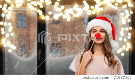 happy teenage girl in santa hat on christmas happy teenage girl in santa hat on christmas 71927165