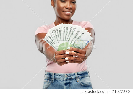 happy african american woman with euro money happy african american woman with euro money 71927220