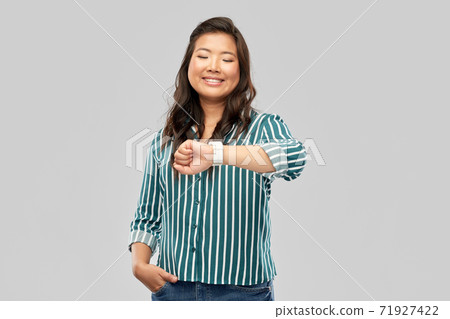 happy smiling woman with smart watch 71927422