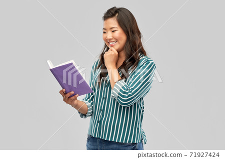 happy asian woman reading book 71927424