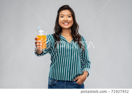 asian woman with juice in plastic cup with straw asian woman with juice in plastic cup with straw 71927452