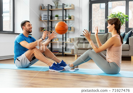 happy couple exercising with ball at home 71927476