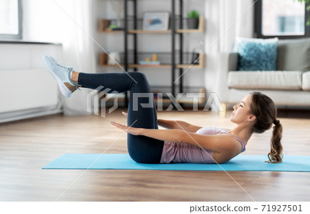 woman exercising at home woman exercising at home 71927501