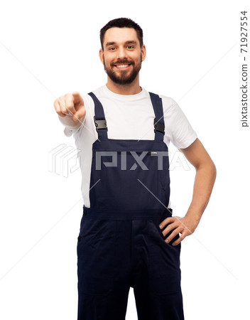 smiling male worker or builder pointing to camera 71927554
